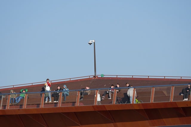 Artisan polishing a rusted metal railing